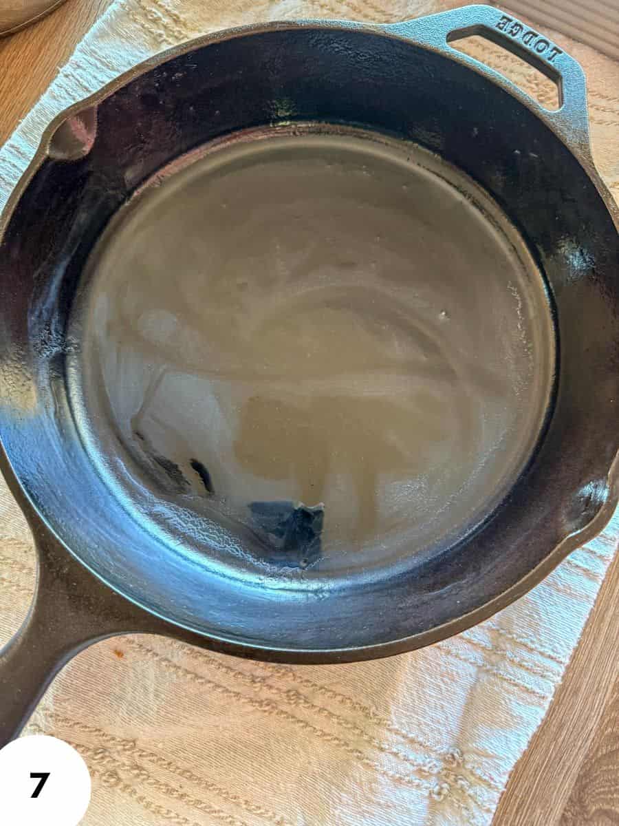 Cast iron skillet with water for bread stretch and fold technique.