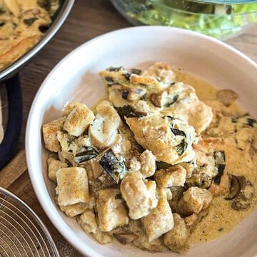 Creamy mushroom and tofu salad in a white bowl for healthy eating.