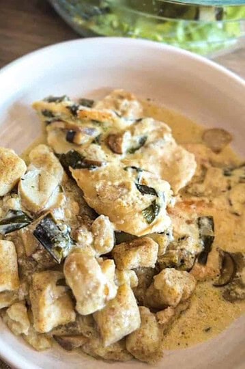 Creamy mushroom and tofu salad in a white bowl for healthy eating.