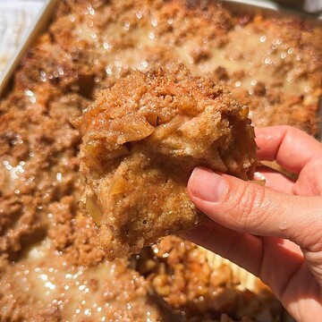 Close-up of a slice of homemade meatloaf with a crispy crust.