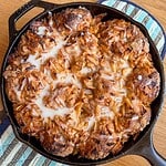 Delicious apple pie pull-apart baked in a skillet with caramelized apples and melted cheese.