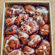 Close-up of cinnamon rolls with icing glaze on top.