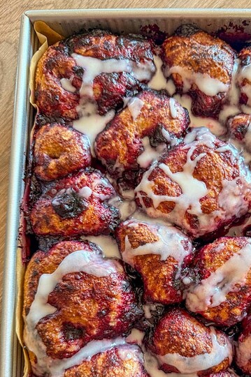 Close-up of cinnamon rolls with icing glaze on top.