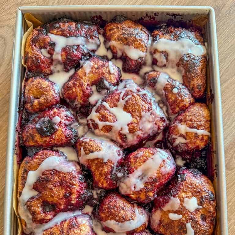 Close-up of cinnamon rolls with icing glaze on top.