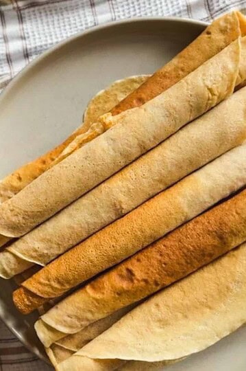 Assorted homemade wraps and flatbreads on a plate for baking and cooking.