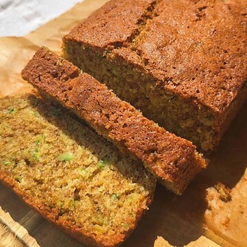 Close-up of freshly baked banana bread slices on a wooden surface.
