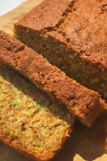 Close-up of freshly baked banana bread slices on a wooden surface.