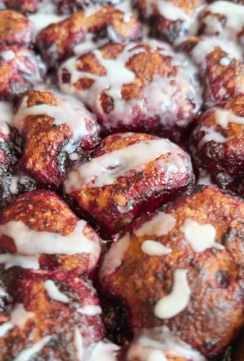 Close-up of baked cherry clafoutis with glaze and powdered sugar.
