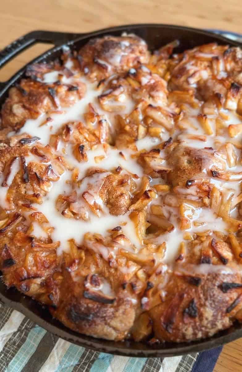 Close-up of baked chicken with caramelized onions and melted cheese.