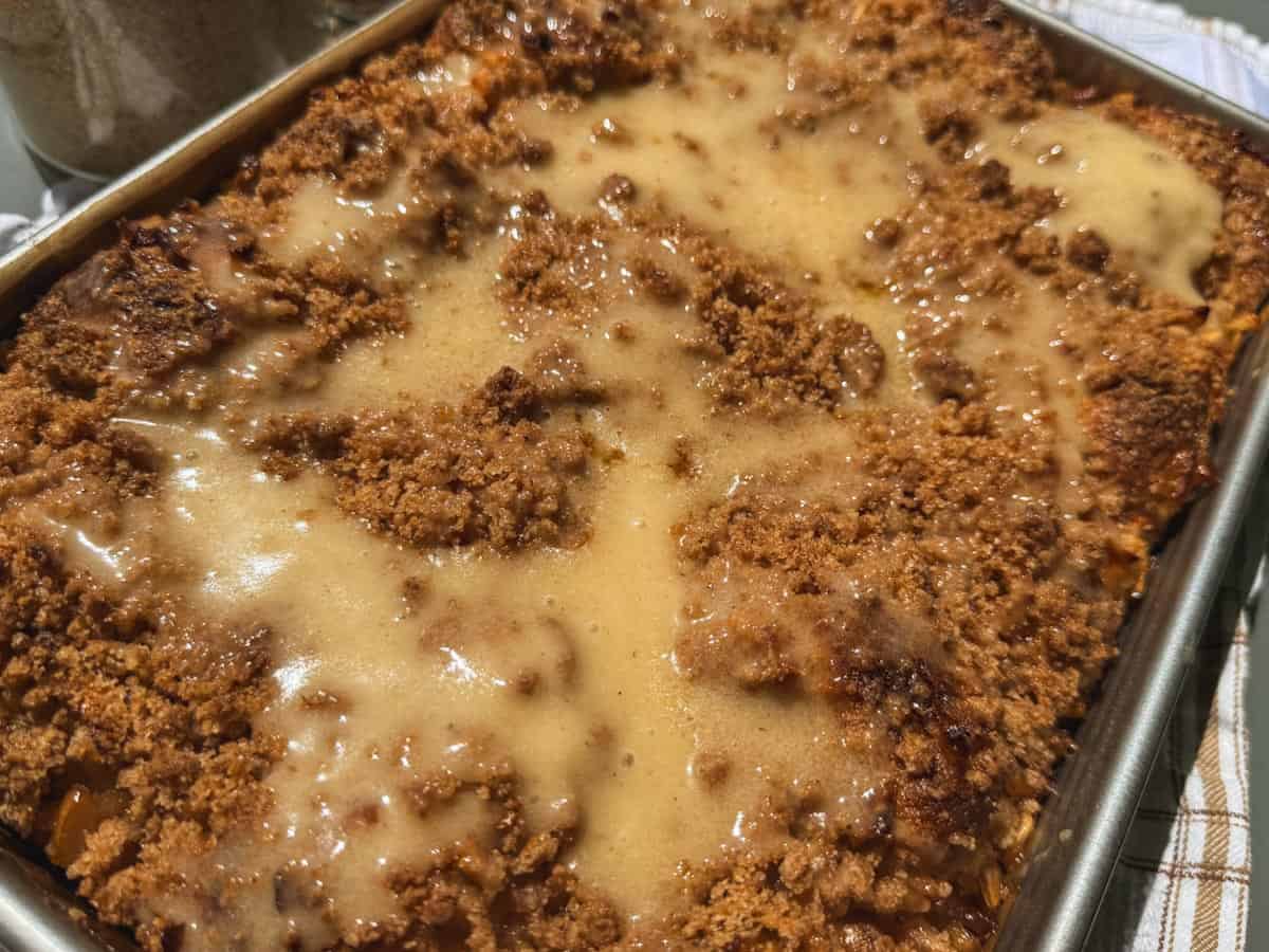 Freshly baked bread with crumb topping and melted butter.