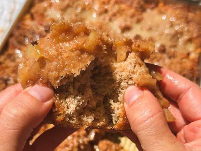 Close-up of hands folding dough during bread baking process.