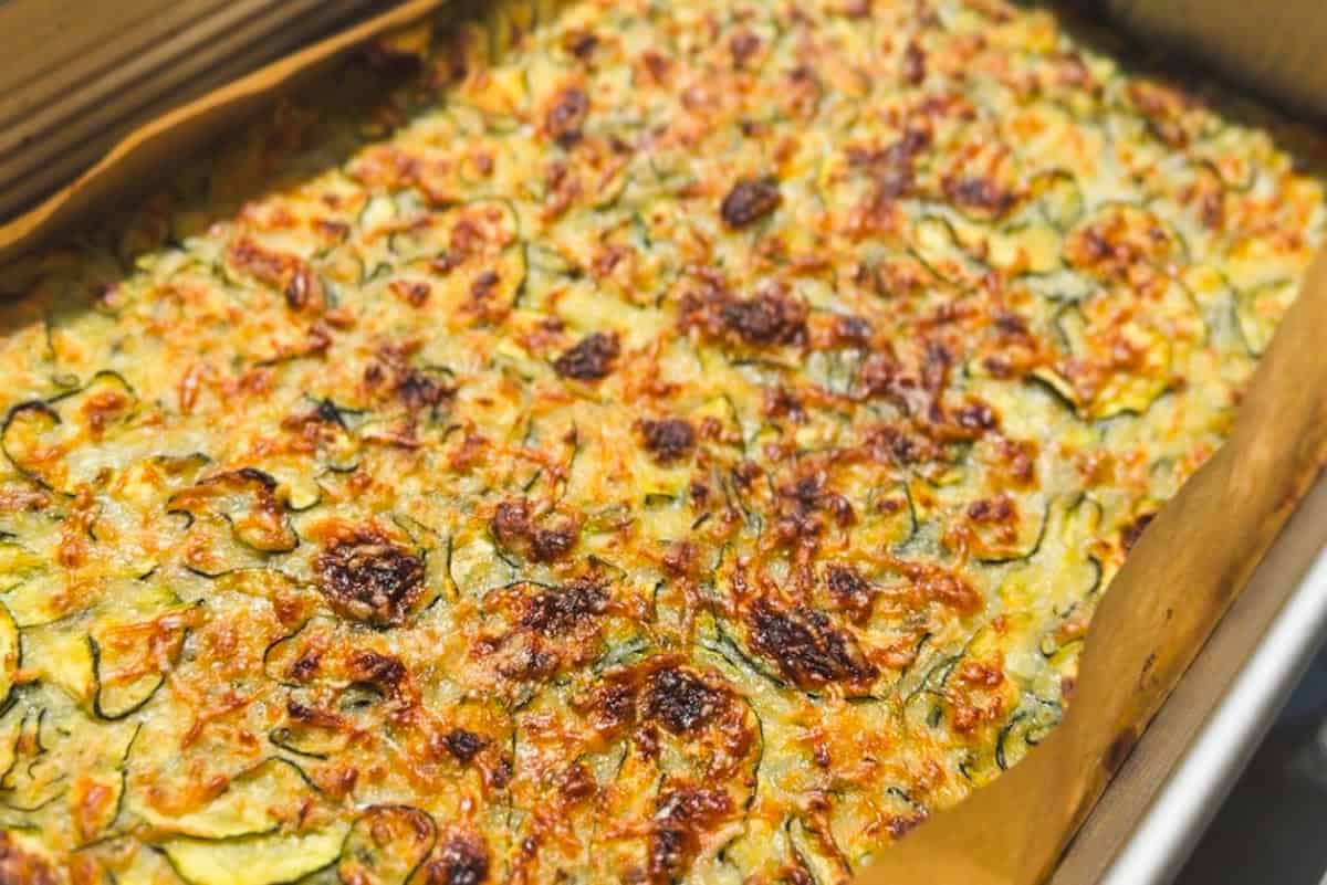 Baked vegetable frittata with cheese and herbs in a baking dish.