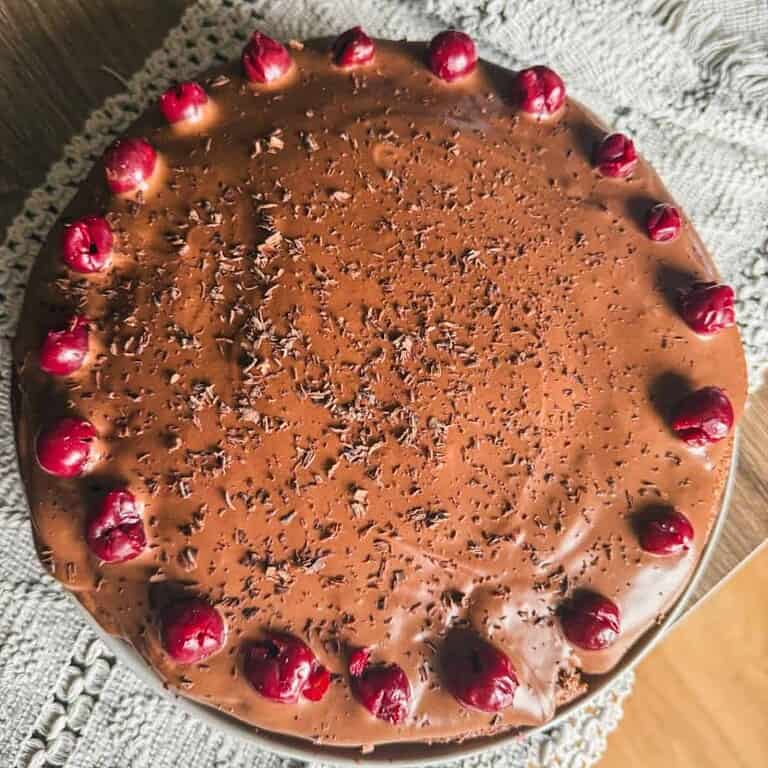 Delicious chocolate cake topped with cherries and chocolate shavings.