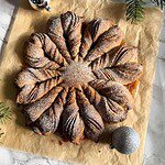 Star-shaped pastry dusted with powdered sugar on parchment paper.