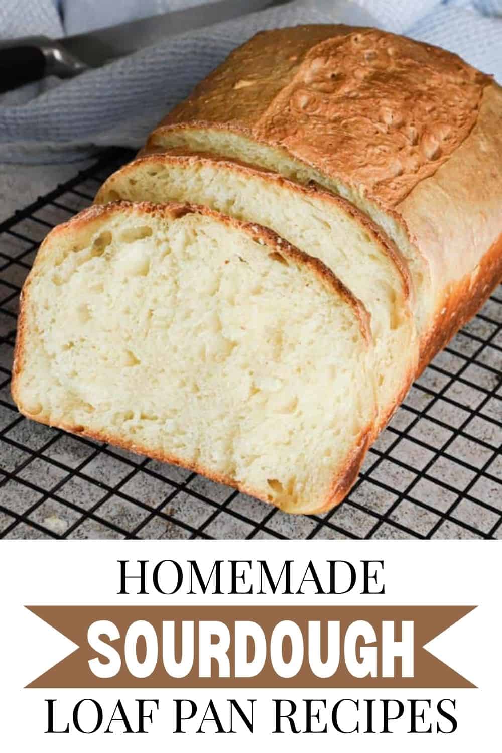 Freshly baked sourdough bread loaf on cooling rack, sliced open.