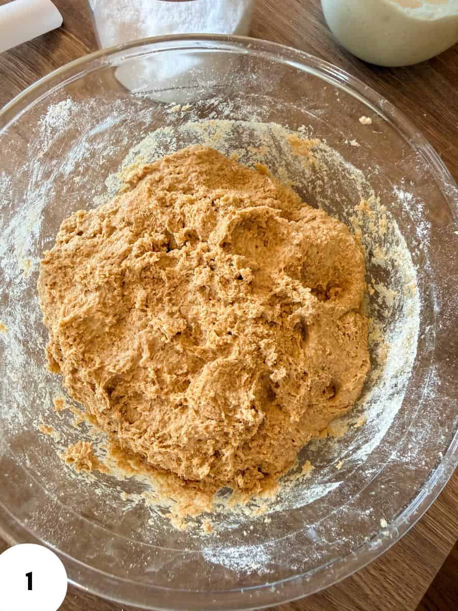 Mixing dough in a glass bowl for bread baking process.