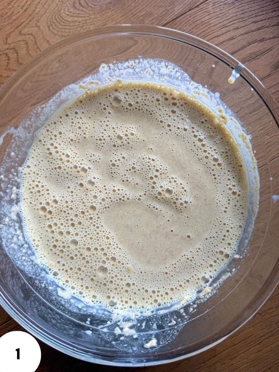 Bowl of bubbly dough for bread making with stretch and fold technique.