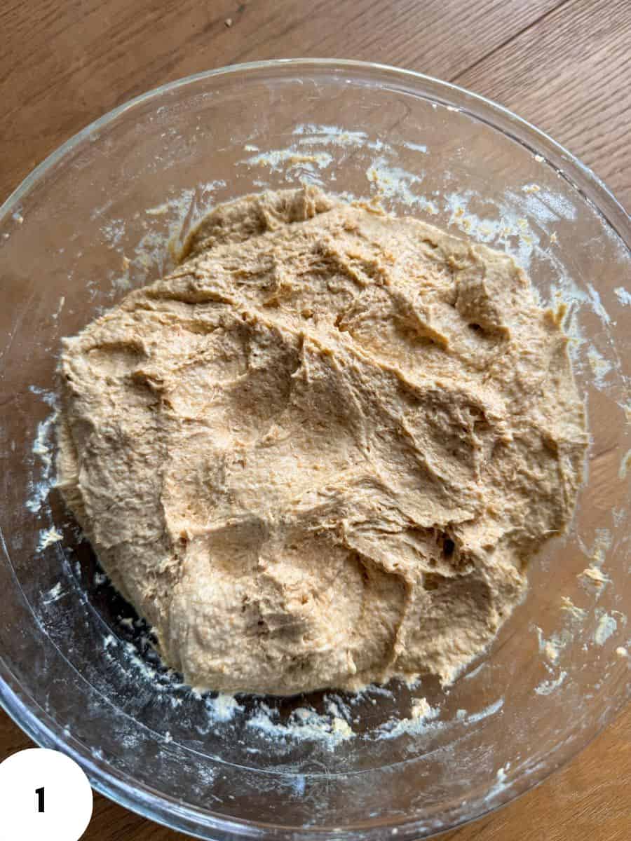 Dough in a glass bowl ready for stretch and fold technique.