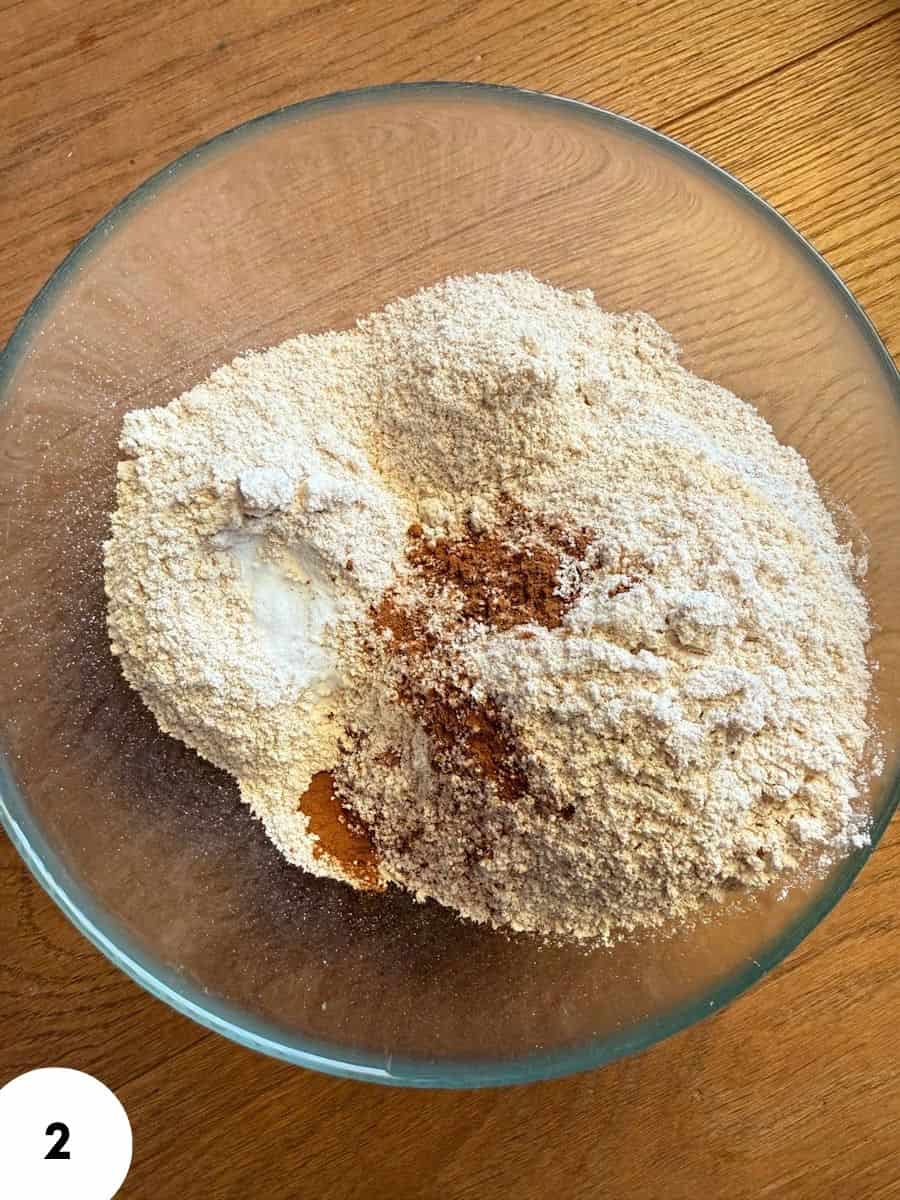 Close-up of einkorn flour and spices in a glass bowl for baking.