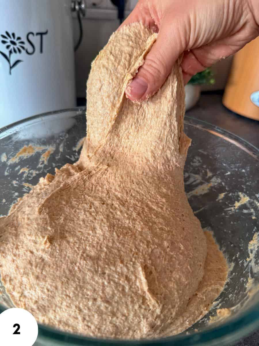 Dough being stretched and folded during bread making process.