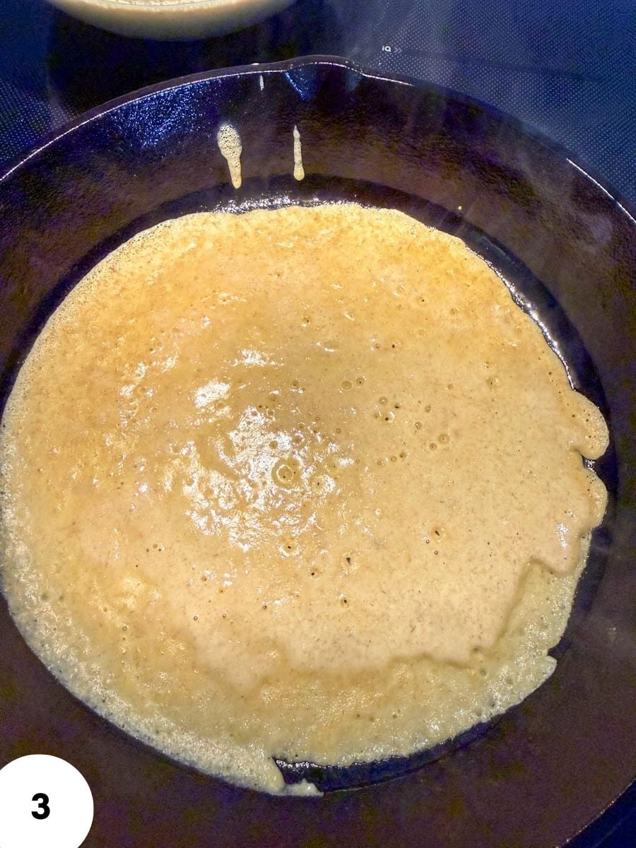 Bread dough in a skillet during stretch and fold process for baking.