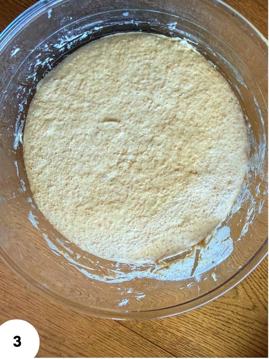 Dough in a glass bowl ready for stretch and folds technique.