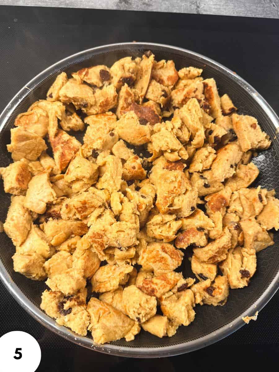 Close-up of golden homemade bread crumbs on a black plate.