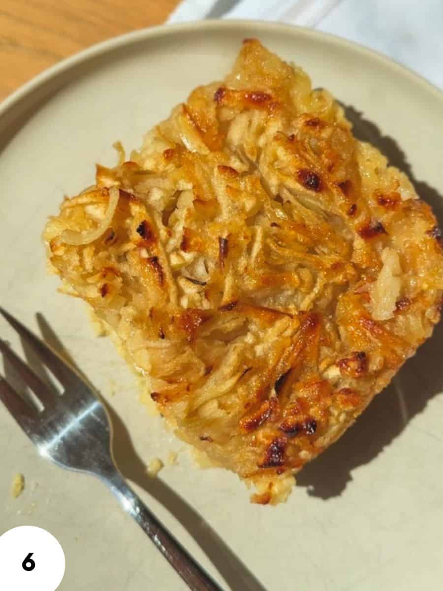 Close-up of a slice of homemade apple pie on a white plate.