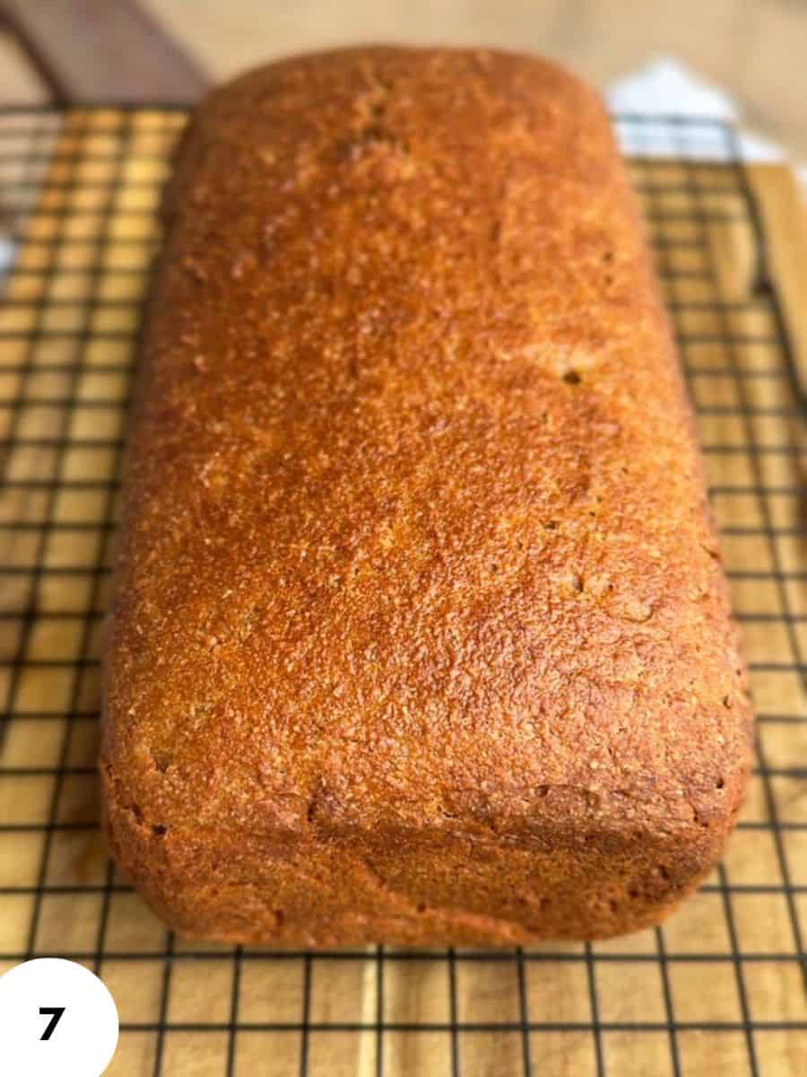 Freshly baked bread loaf on cooling rack, perfect for bread baking.