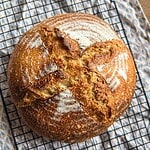 Freshly baked sourdough bread with a golden crust and scoring marks.
