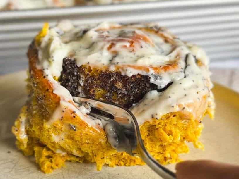 Close-up of a savory breakfast casserole with yogurt and herbs on top.
