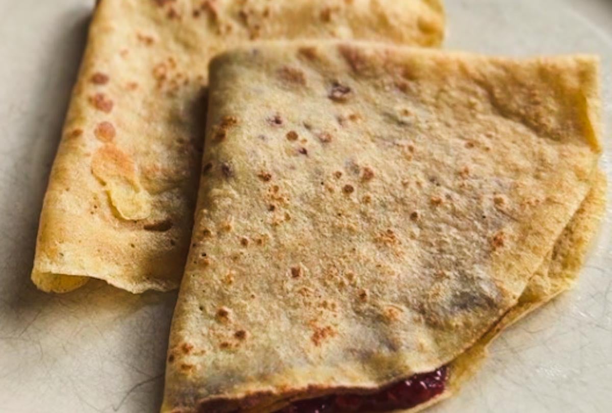Close-up of folded flatbread with a golden-brown crust and filling.