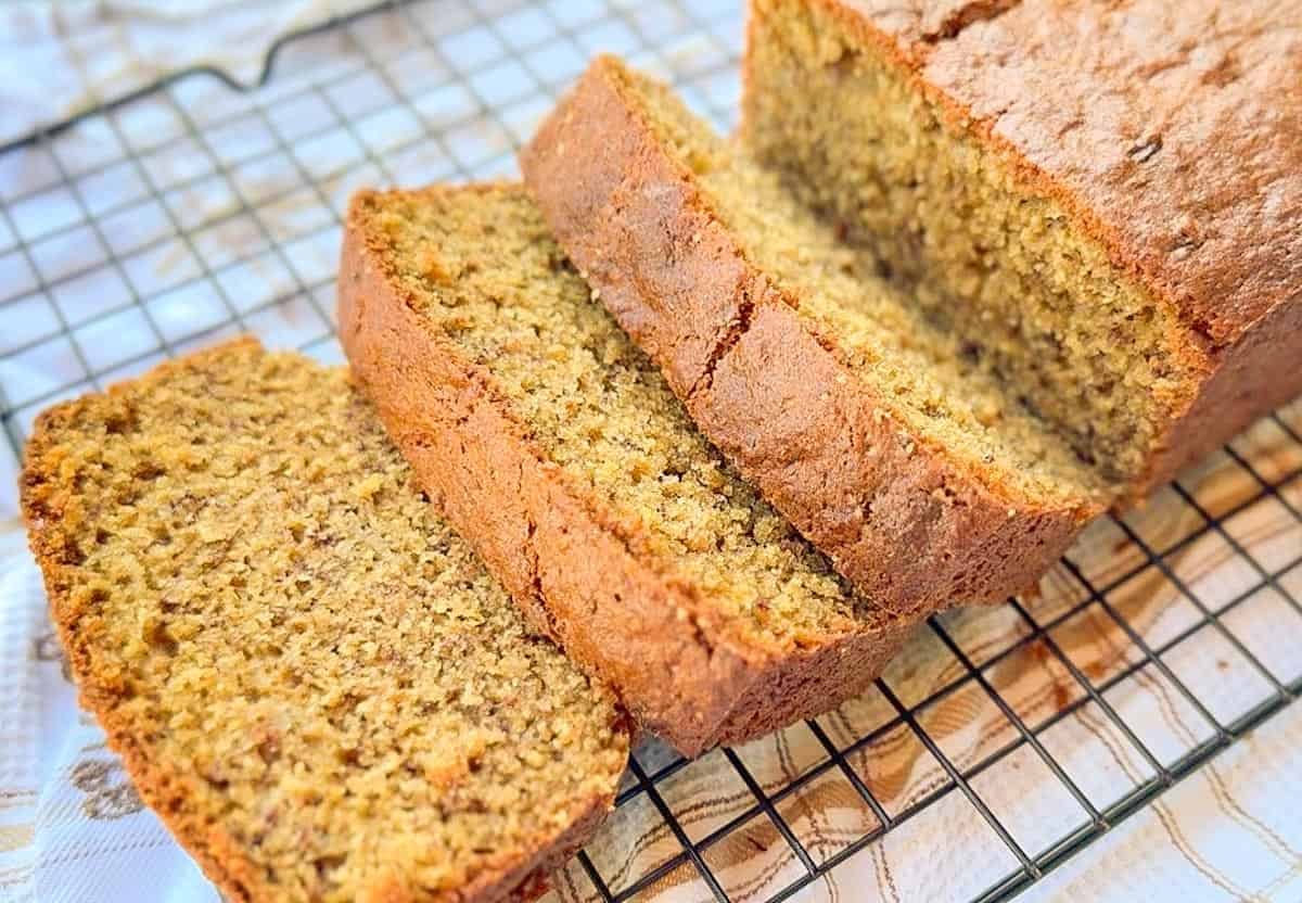 Freshly baked einkorn banana bread slices on a cooling rack.