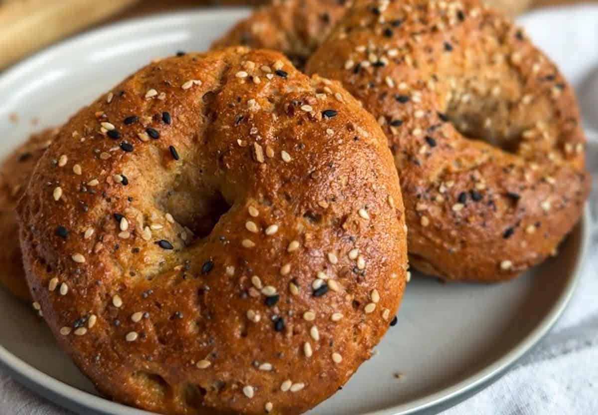 Close-up of freshly baked bagels with sesame seeds on top.