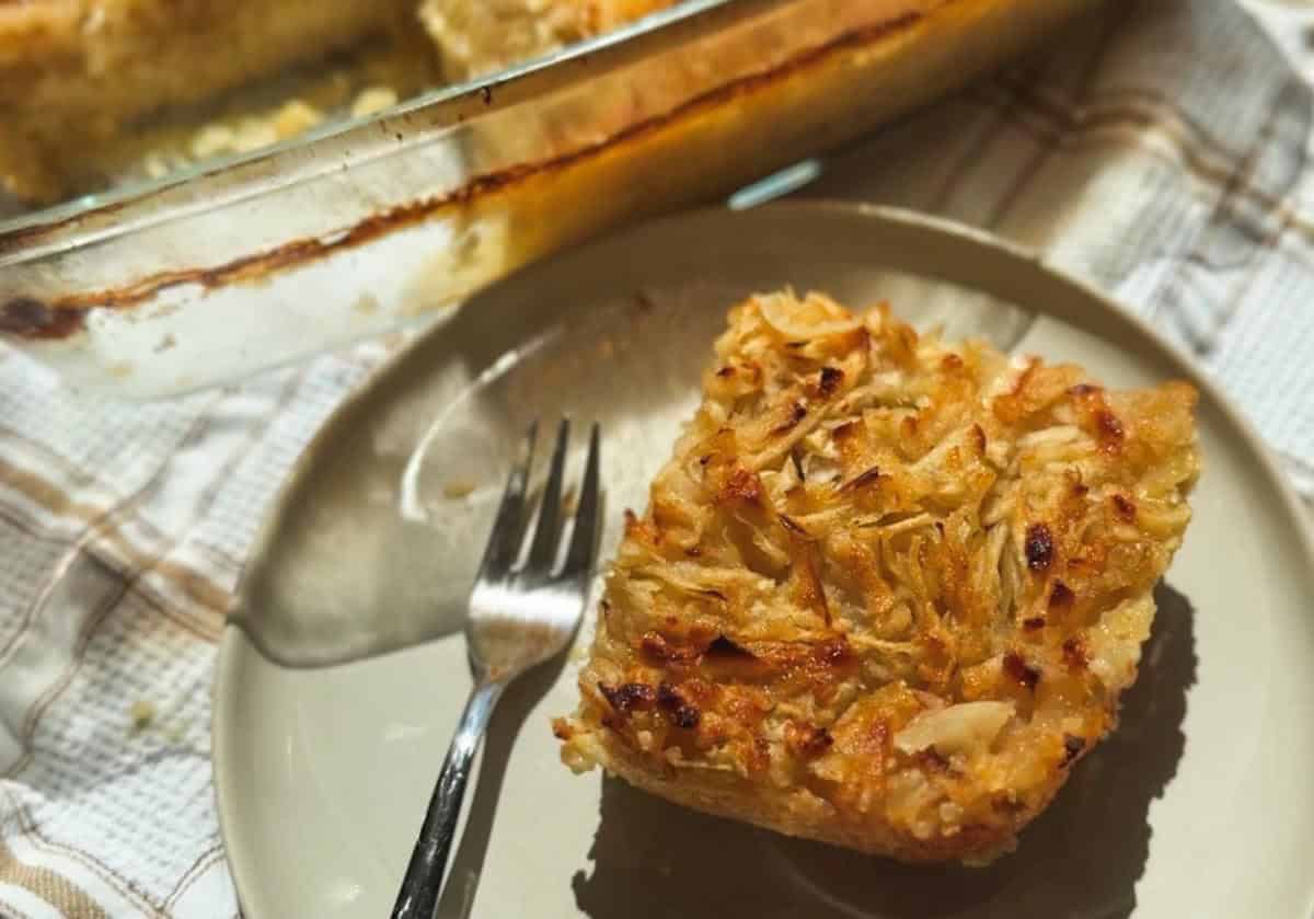 Close-up of a slice of tuna casserole with crispy topping on a white plate.