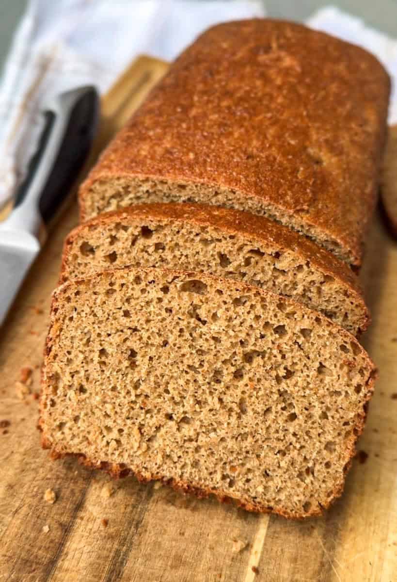 Homemade whole wheat bread loaf with a golden crust and soft interior.