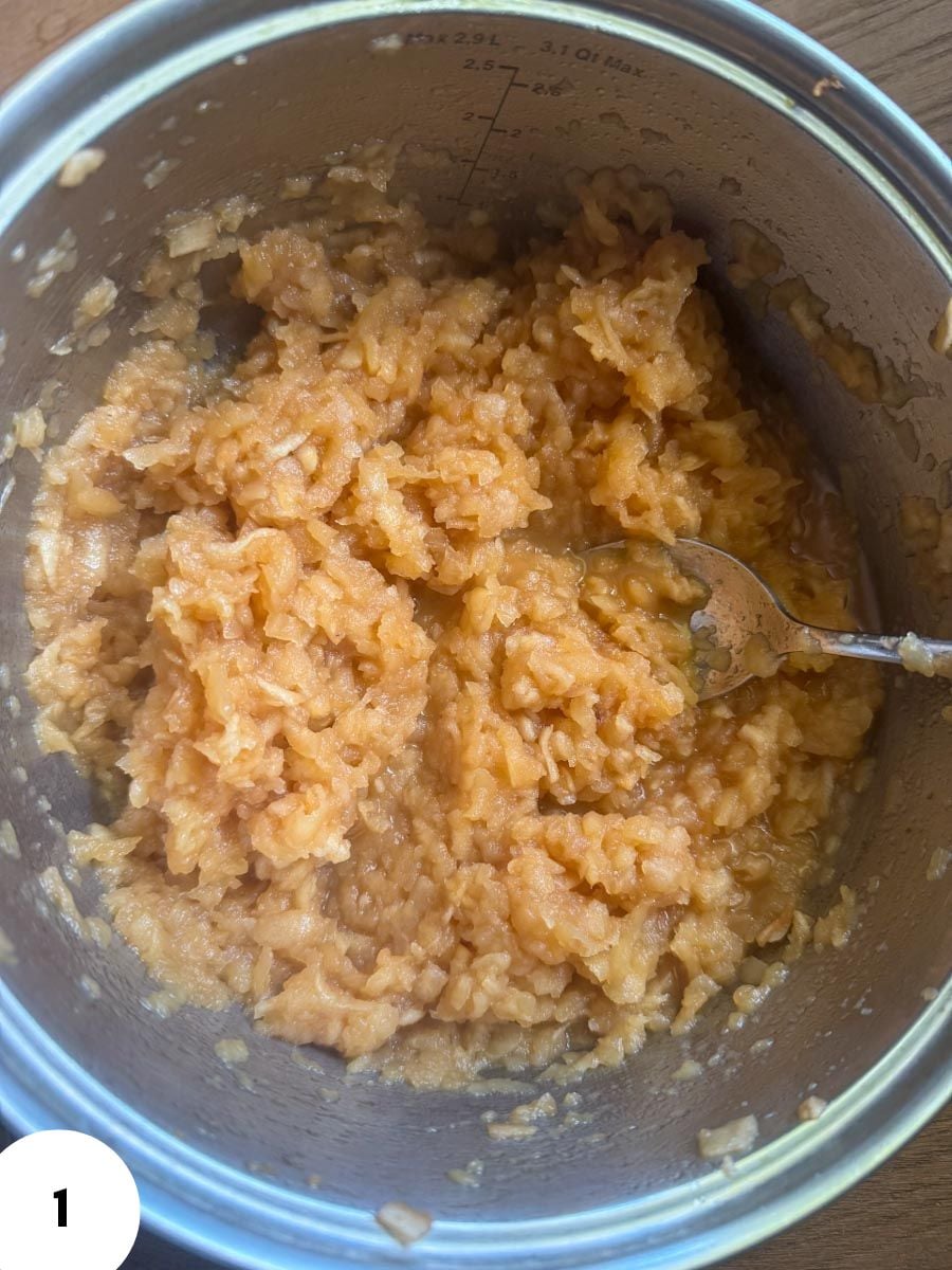 Fermented dough in a glass bowl with a spoon for bread baking.