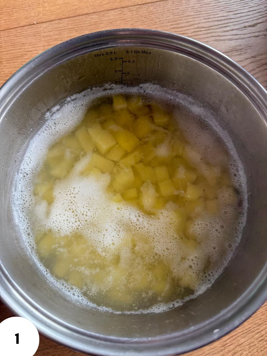 Diced potatoes soaking in a mixing bowl for bread dough.