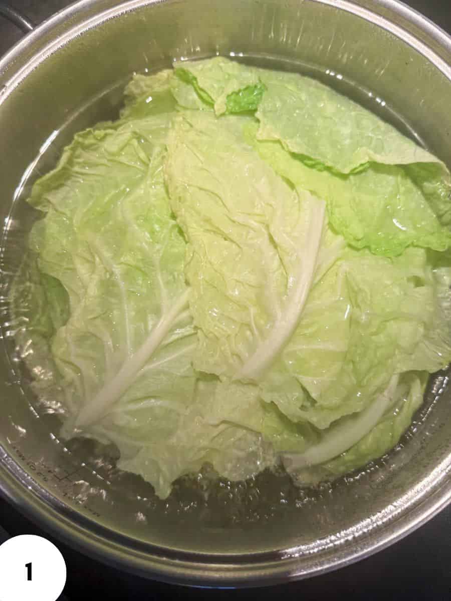 Fresh green lettuce leaves in a metal bowl for crisp salad prep.