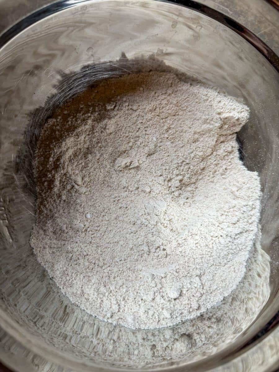 fresh milled Flour mixture in a glass bowl for bread dough preparation.