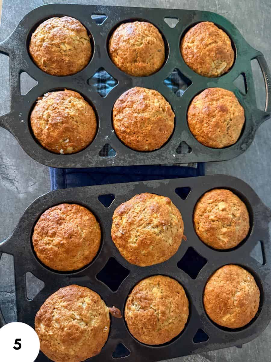 Golden brown bread rolls cooling on baking racks.