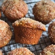 Close-up of homemade muffins with sugar topping on a cooling rack.