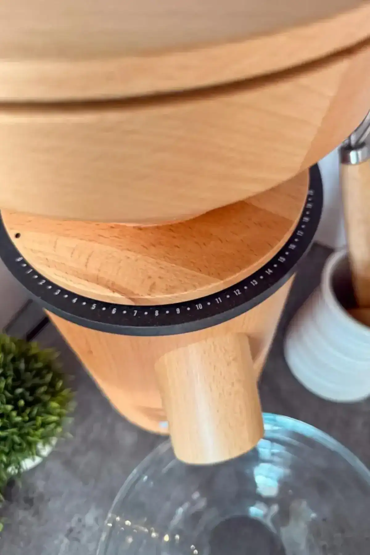 Close-up of the numbered grind setting ring beneath the wooden hopper of the Mockmill Lino 200.